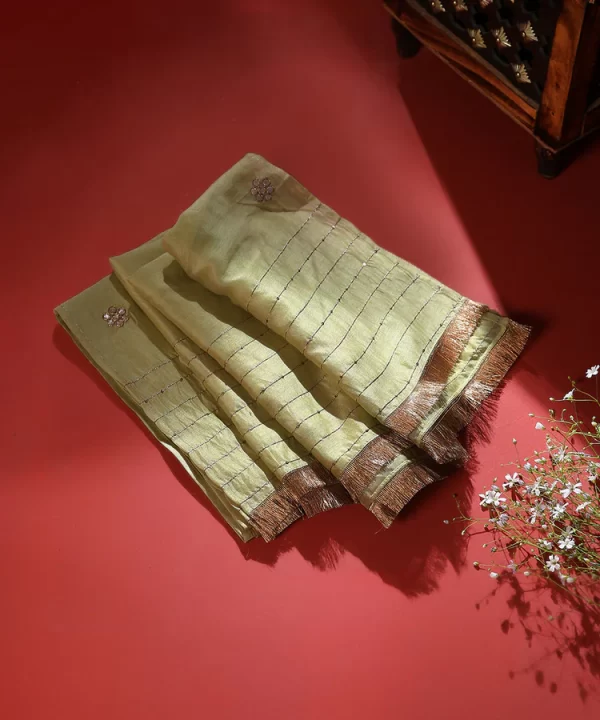 Discover the elegance of our Lime Green Silk Dupatta, adorned with intricate Gota floral booties and CoutureCraze lace. Perfect for weddings and festive occasions, this piece adds vibrant charm to any outfit.