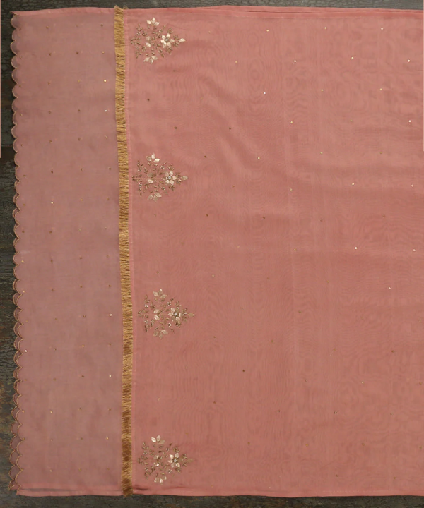 Add elegance to your look with our Pink Silk Dupatta featuring intricate gota patti work and a sheer organza border. Perfect for festive occasions. by couturecraze