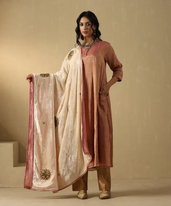 Elegant off-white velvet doshala with intricate zardozi embroidery and contrast Chanderi tissue border. Perfect for weddings and festive events, adding timeless luxury. by couturecraze