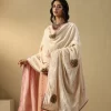 Elegant off-white velvet doshala with intricate zardozi embroidery and contrast Chanderi tissue border. Perfect for weddings and festive events, adding timeless luxury. by couturecraze