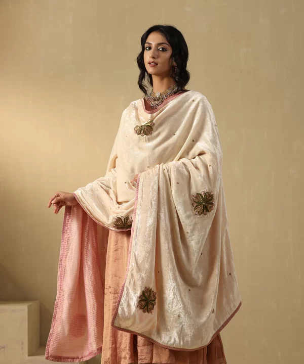 Elegant off-white velvet doshala with intricate zardozi embroidery and contrast Chanderi tissue border. Perfect for weddings and festive events, adding timeless luxury. by couturecraze