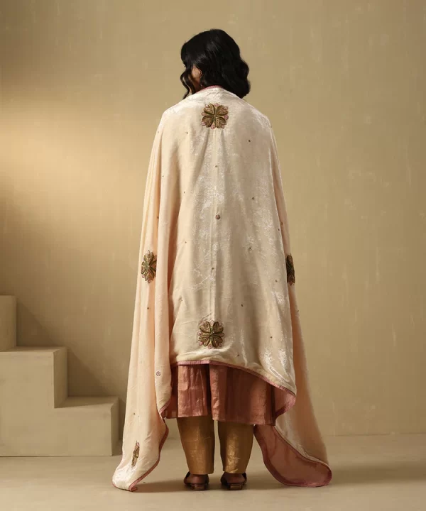 Elegant off-white velvet doshala with intricate zardozi embroidery and contrast Chanderi tissue border. Perfect for weddings and festive events, adding timeless luxury. by couturecraze