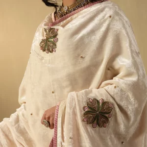Elegant off-white velvet doshala with intricate zardozi embroidery and contrast Chanderi tissue border. Perfect for weddings and festive events, adding timeless luxury. by couturecraze