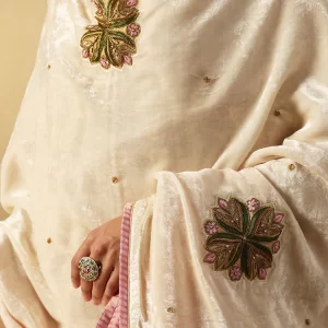 Elegant off-white velvet doshala with intricate zardozi embroidery and contrast Chanderi tissue border. Perfect for weddings and festive events, adding timeless luxury. by couturecraze