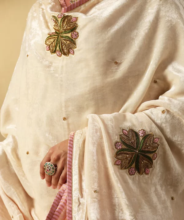 Elegant off-white velvet doshala with intricate zardozi embroidery and contrast Chanderi tissue border. Perfect for weddings and festive events, adding timeless luxury. by couturecraze