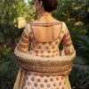 Open-back blouse design with cutwork on blush pink gold CoutureCraze lehenga set