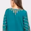 Teal ethnic dress with scattered gold embellishments and embroidered neckline.