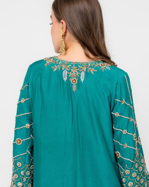 Teal ethnic dress with scattered gold embellishments and embroidered neckline.