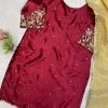 Back view: Embellished maroon ethnic dress with scattered gold motifs and ornate sleeve ends.