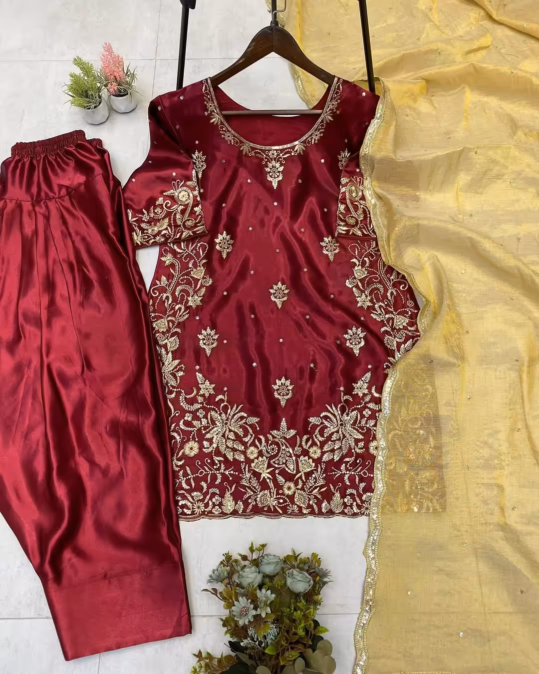 Sleeve close-up: Intricate gold floral embroidery detail on maroon ethnic dress sleeve.