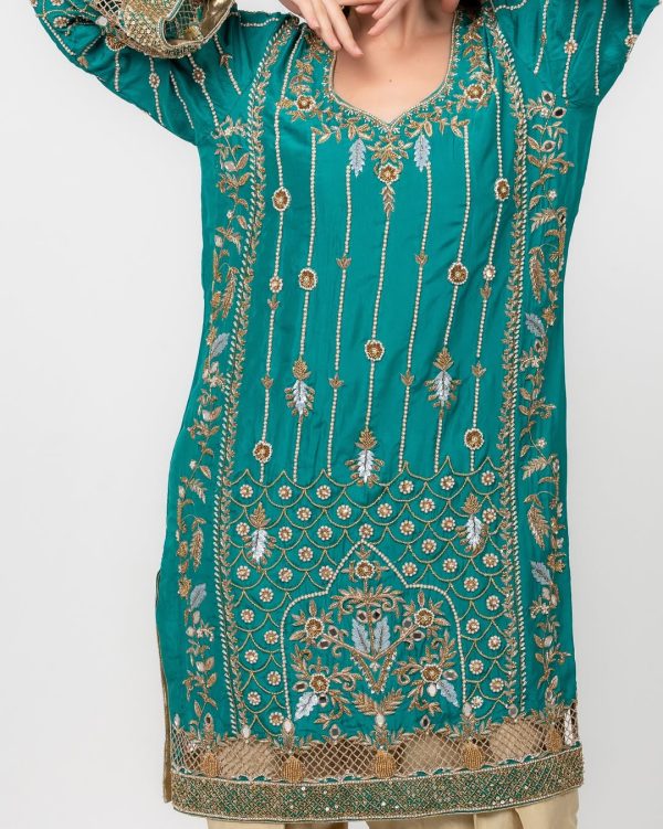 Ornate golden threadwork and beading on ethnic kurta