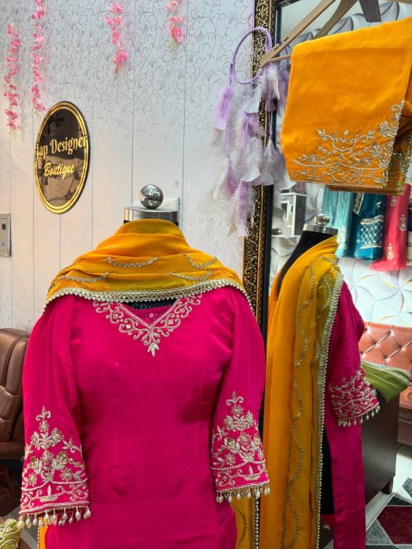 Embroidery closeup: hot pink CoutureCraze suit with pearl tassels and mustard dupatta