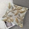Luxury golden embroidered cushion cover with leaf motifs and silver bead accents, ideal for festive home decoration.