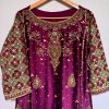 Ornate hand-embroidered lattice sleeve detail on maroon ethnic dress.