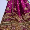 Ornate hand-embroidered lattice sleeve detail on maroon ethnic dress.