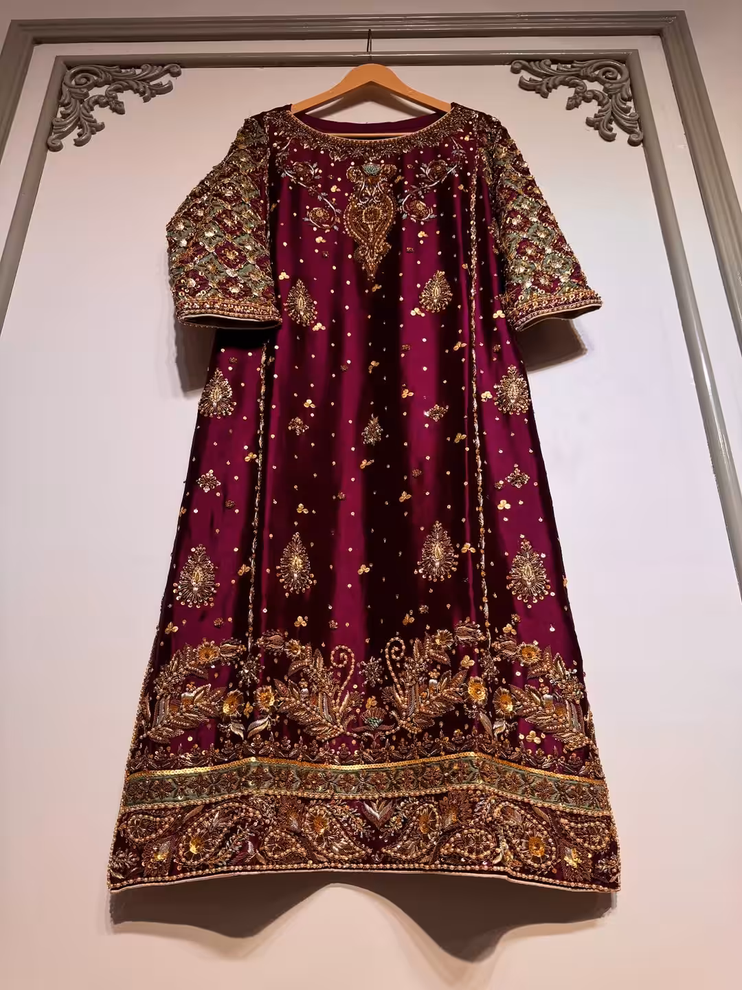Luxury maroon ethnic dress with gold and silver hand embroidery, flared cut, CoutureCraze 2025.