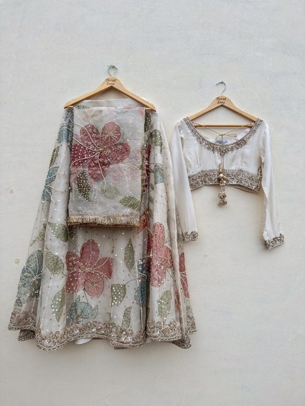 Luxury pastel floral embroidered lehenga set in ivory with blouse and dupatta, CoutureCraze 2025.