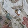 Full-sleeve blouse with ornate neckline, cuffs, and beadwork.