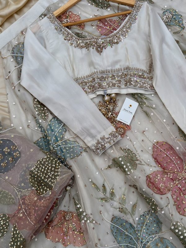 Full-sleeve blouse with ornate neckline, cuffs, and beadwork.