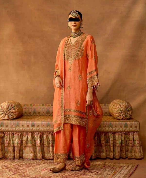 Full view of peach gold embroidered salwar suit set with ornate zari and sequin work