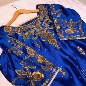 Royal blue silk kurta with intricate gold embroidery, paired with matching bottoms and a gold-bordered dupatta