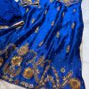 Royal blue silk kurta with intricate gold embroidery, paired with matching bottoms and a gold-bordered dupatta