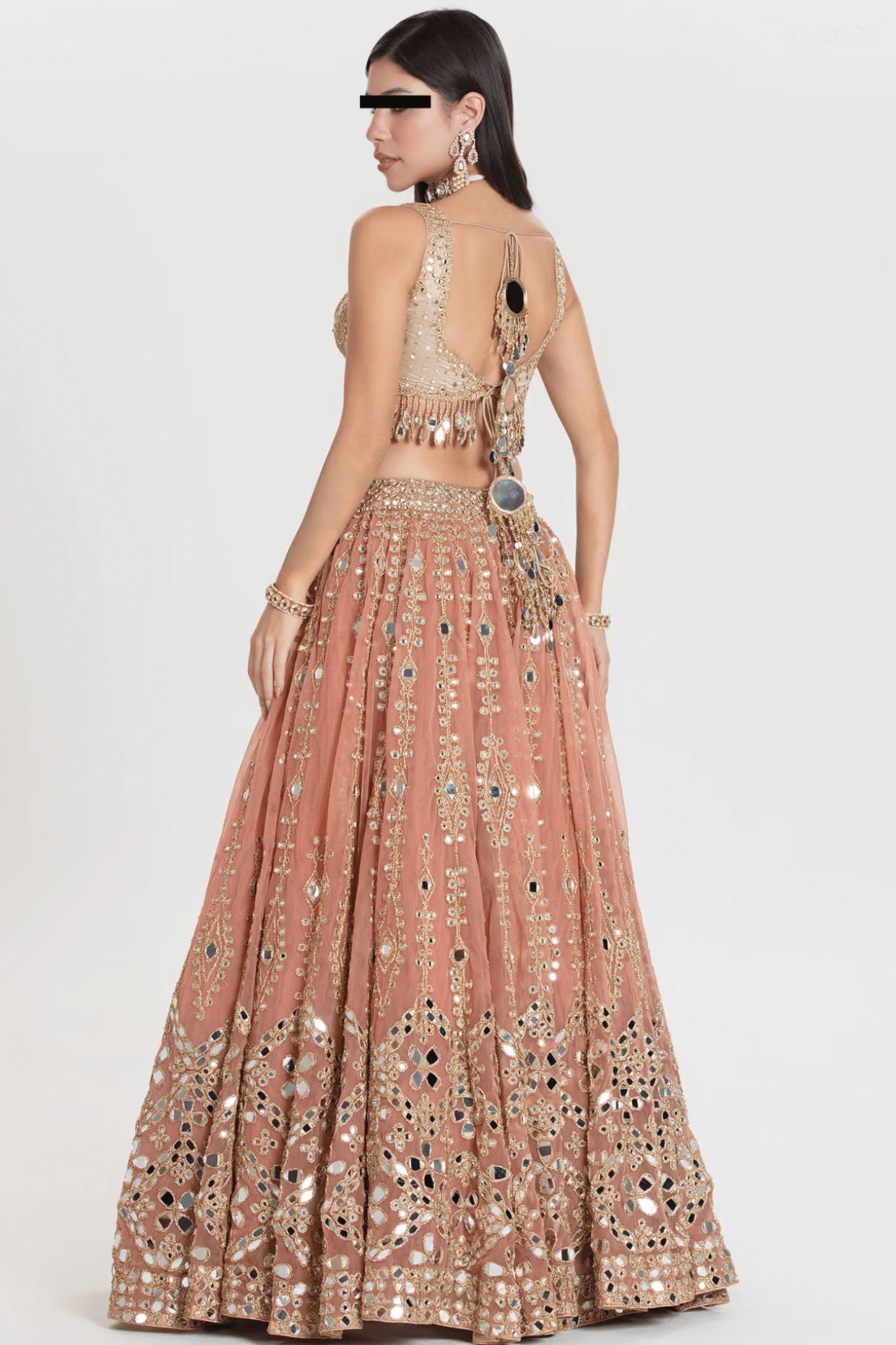 Peach net lehenga with mirror and thread embroidery, styled for wedding wear by Couturecraze