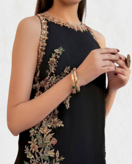 Close-up of black embroidered straight suit with gold floral vine embroidery and sleeveless neckline.