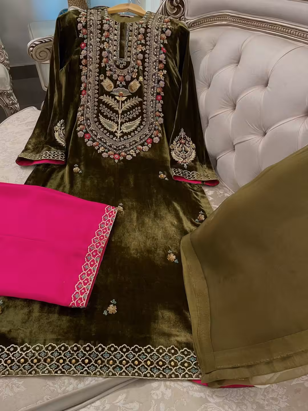 Olive green velvet suit with hand embroidered French velvet shirt, raw silk trousers and organza dupatta